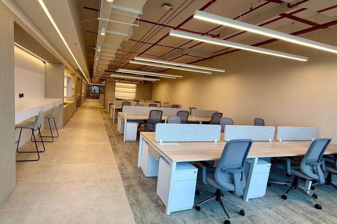 Zodder Services: Open workstations with blue chairs and linear lighting