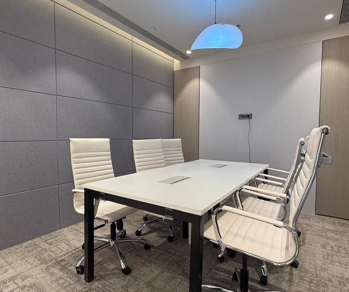 Zodder Services: Enclosed meeting room with a white table